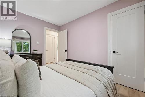 Light wood-finish flooring, white trim, and modern interior doors with matte black hardware - 8 Christian Street, Baden, ON 