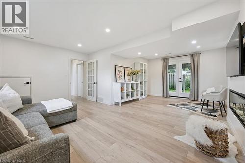 Light wood-finish flooring with recessed lighting - 8 Christian Street, Baden, ON 
