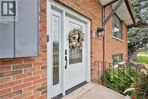 Brick exterior with a light-colored entry door and sidelight - 8 Christian Street, Baden, ON 