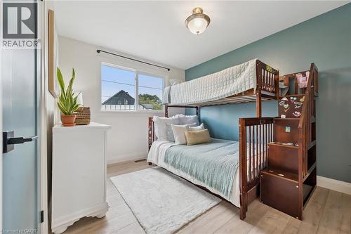 Light wood-finish flooring, white walls, a single window, and a ceiling-mounted light fixture - 8 Christian Street, Baden, ON 