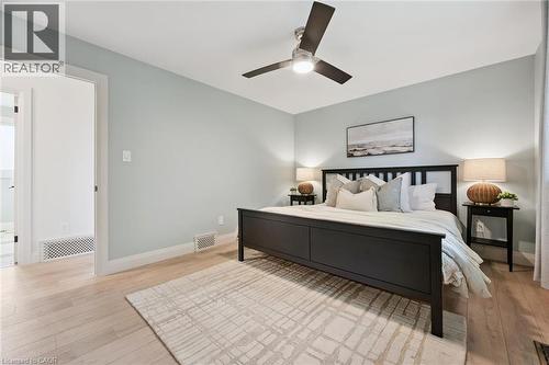 Light wood-finish flooring with a ceiling fan overhead - 8 Christian Street, Baden, ON 