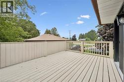 Expansive outdoor deck with wood flooring and a privacy fence - 