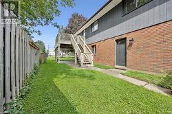 Brick and siding exterior with a wooden deck and staircase - 