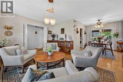 Parquet wood flooring, sliding glass patio doors, and a multi-light pendant fixture - 