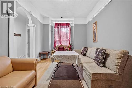Archway entry with decorative columns, light wood-finish flooring, and crown molding - 199 N Locke Street N, Hamilton, ON 