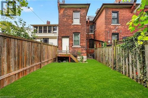 Manicured lawn with wood fencing - 199 N Locke Street N, Hamilton, ON 
