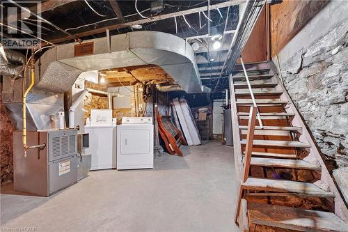 Concrete flooring and exposed stone foundation walls - 199 N Locke Street N, Hamilton, ON 