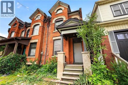 Brick facade with decorative arched windows and detailed gables - 199 N Locke Street N, Hamilton, ON 