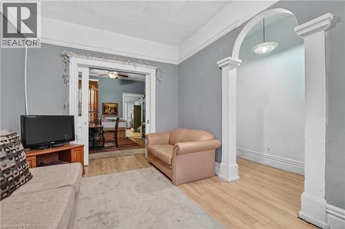 Archway with decorative columns, wood-finish flooring, and crown molding - 199 N Locke Street N, Hamilton, ON 