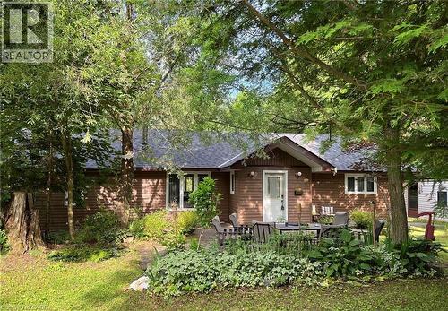 Single-story exterior with brown siding and a dark shingle roof - 16431 Highway 35, Algonquin Highlands, ON 