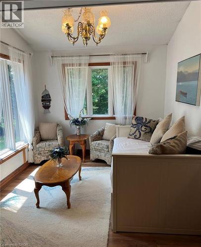 Wood-finish flooring, multiple windows, and a classic brass chandelier - 16431 Highway 35, Algonquin Highlands, ON 
