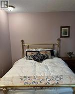Ceiling-mounted light fixture, painted walls, and wood-finish side table - 
