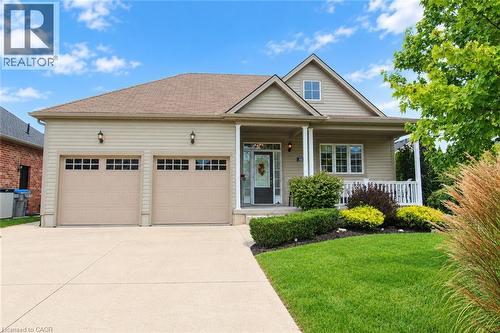 Pitched roof dwelling with beige siding and two-car garage - 40 Stornoway Crescent, Huron East, ON 