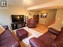 Wood-finish flooring throughout, complemented by a built-in entertainment console with an integrated electric fireplace - 40 Stornoway Crescent, Huron East, ON 