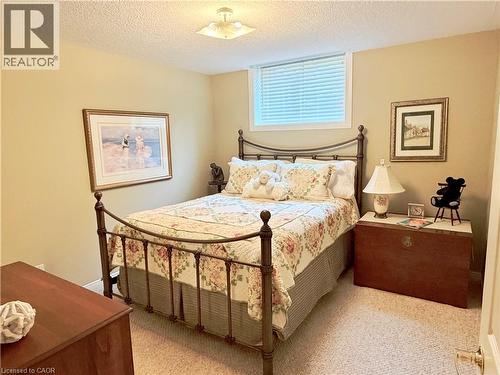 Carpeted flooring, window with blinds, and ceiling-mounted light fixture - 40 Stornoway Crescent, Huron East, ON 
