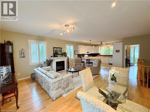Hardwood flooring, white window shutters, built-in fireplace, recessed lighting, and track lighting - 40 Stornoway Crescent, Huron East, ON 