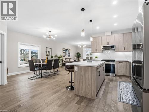 Kitchen with open floor plan, stainless steel appliances, modern cabinets, and a kitchen bar - 230 Knoll Street, Port Colborne, ON 