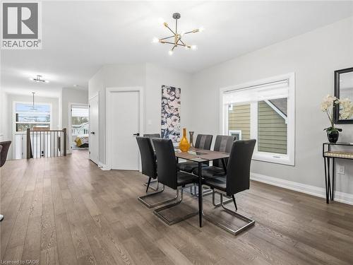 Dining space featuring hanging lights and wood finished floors - 230 Knoll Street, Port Colborne, ON 