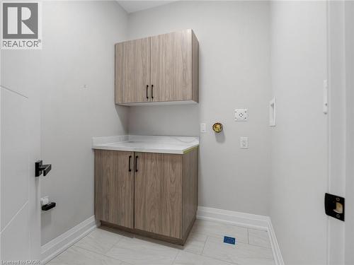 Laundry room with cabinet space and baseboards - 230 Knoll Street, Port Colborne, ON 