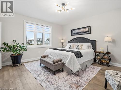 Bedroom featuring light wood-style flooring and a chandelier - 230 Knoll Street, Port Colborne, ON 