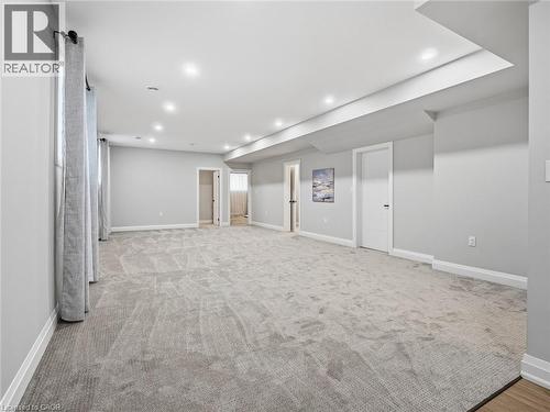 Below grade area with light carpet and recessed lighting - 230 Knoll Street, Port Colborne, ON 