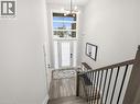 Foyer entrance with a high ceiling, wood finished floors, and suspended lighting - 230 Knoll Street, Port Colborne, ON 