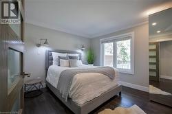 Dark wood-finish flooring with crisp white baseboards - 