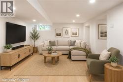 Recessed lighting illuminates this bright, open-concept space featuring wood-finish flooring and white walls - 
