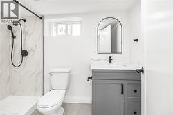 Shower with marble-look tile surround, matte black fixtures, and a glass-enclosed shower - 