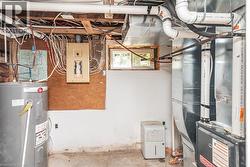 Electrical panel with exposed wiring, water heater, and mechanical systems - 