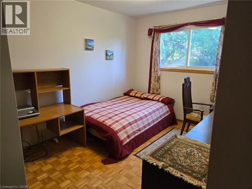 Wood-finish parquet flooring, white wall paint, and a window with natural light - 410 Lakeview Drive, Waterloo, ON 