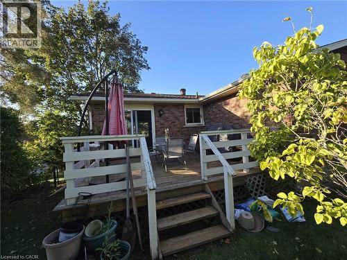 Rear wooden deck featuring steps to a grassy yard - 410 Lakeview Drive, Waterloo, ON 