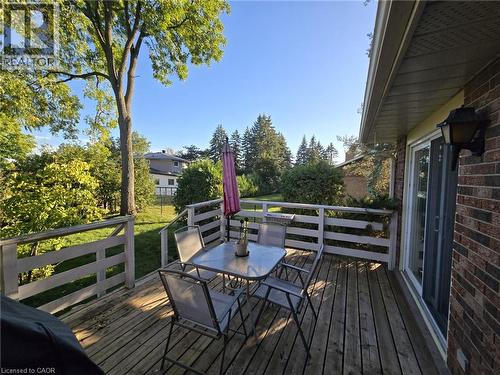 Expansive wood deck with horizontal railing, featuring direct access via a sliding glass door - 410 Lakeview Drive, Waterloo, ON 