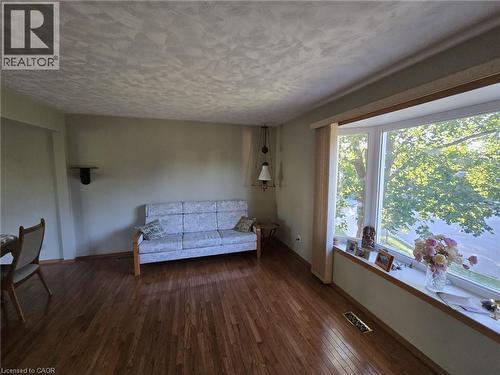 Hardwood flooring, bay window, textured ceiling, pendant light fixture, and light-toned wall finishes - 410 Lakeview Drive, Waterloo, ON 