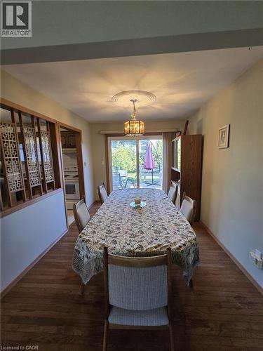 Wood-finish flooring with a ceiling medallion and decorative chandelier - 410 Lakeview Drive, Waterloo, ON 