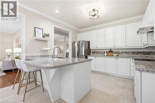 Kitchen with white cabinetry & granite countertops. - 2381 Grand Oak Trail, Oakville, ON 