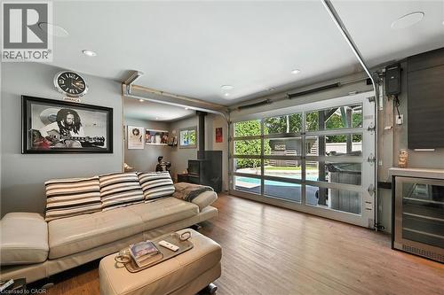 Full-light glass garage door, wood-finish flooring, recessed lighting, built-in cabinetry, and integrated beverage cooler - 2209 Ghent Avenue, Burlington, ON 