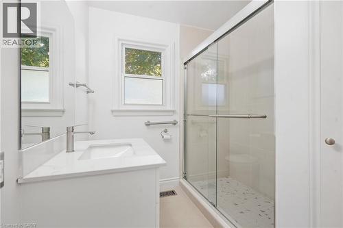 White vanity with integrated sink, modern brushed nickel faucet, and white countertop - 49 Beverly Crescent, Welland, ON 