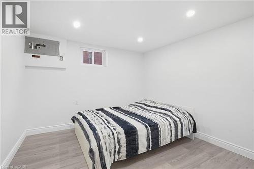 Recessed ceiling lighting, light wood-finish flooring, white painted walls, and a window - 49 Beverly Crescent, Welland, ON 