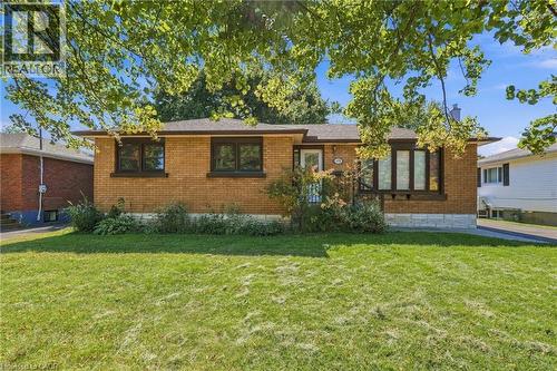 Brick exterior with stone accents, covered front entry, and a prominent front lawn - 49 Beverly Crescent, Welland, ON 