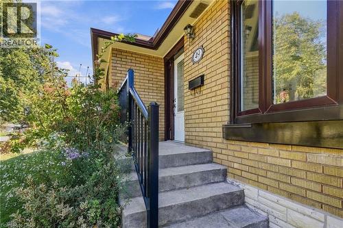 Brick exterior with concrete stairs and a black metal railing - 49 Beverly Crescent, Welland, ON 