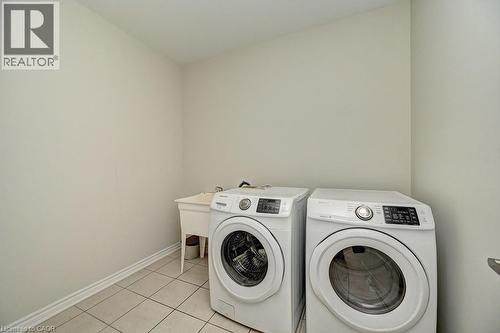 Laundry area with tiled flooring and a utility sink - 236 Ridge Road, Cambridge, ON 