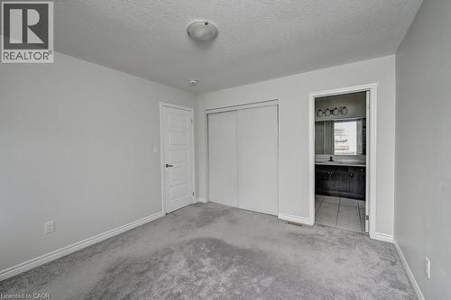 Light gray carpeting, white walls, and a ceiling-mounted light fixture - 236 Ridge Road, Cambridge, ON 