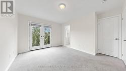 Upper Floor Primary Bedroom Leading to Balcony - 