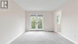 Primary Bedroom with Balcony Overlooking Backyard - 