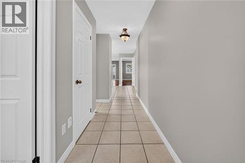 Tile flooring throughout, neutral wall tones, white interior doors, and overhead lighting fixtures - 795 Tenth Avenue, Hamilton, ON 