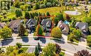 Two-story residence featuring a gray shingle roof, attached garage, and a paved driveway - 74 Davidson Boulevard, Dundas, ON 