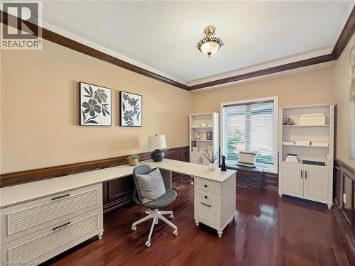 Rich wood-finish flooring, built-in shelving, and a prominent window with a built-in bench - 74 Davidson Boulevard, Dundas, ON 