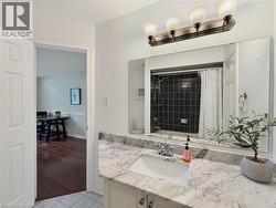 Vanity with a white rectangular sink, stone-finish countertop, and chrome faucet - 