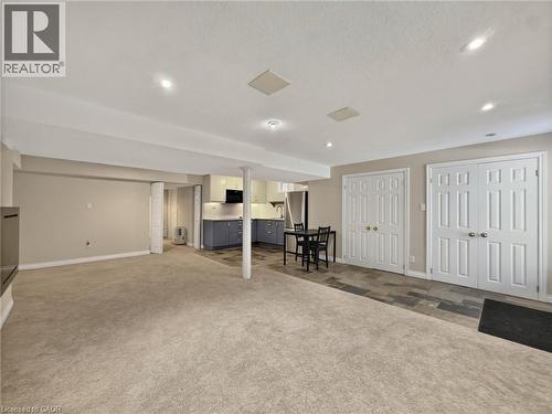 Recessed lighting, wood-finish flooring, two sets of double-door closets, and a built-in kitchen with under-cabinet lighting - 74 Davidson Boulevard, Dundas, ON 